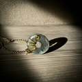 Handmade donut pendant made of green aventurine with gold-colored wire setting